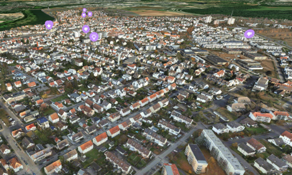 Luftbildaufnahme einer Gemeinde. Auf der Karte sind an bestimmten Standorten in Lila Icons eingefügt, beispielsweise eine Glühbirne, Stern etc.