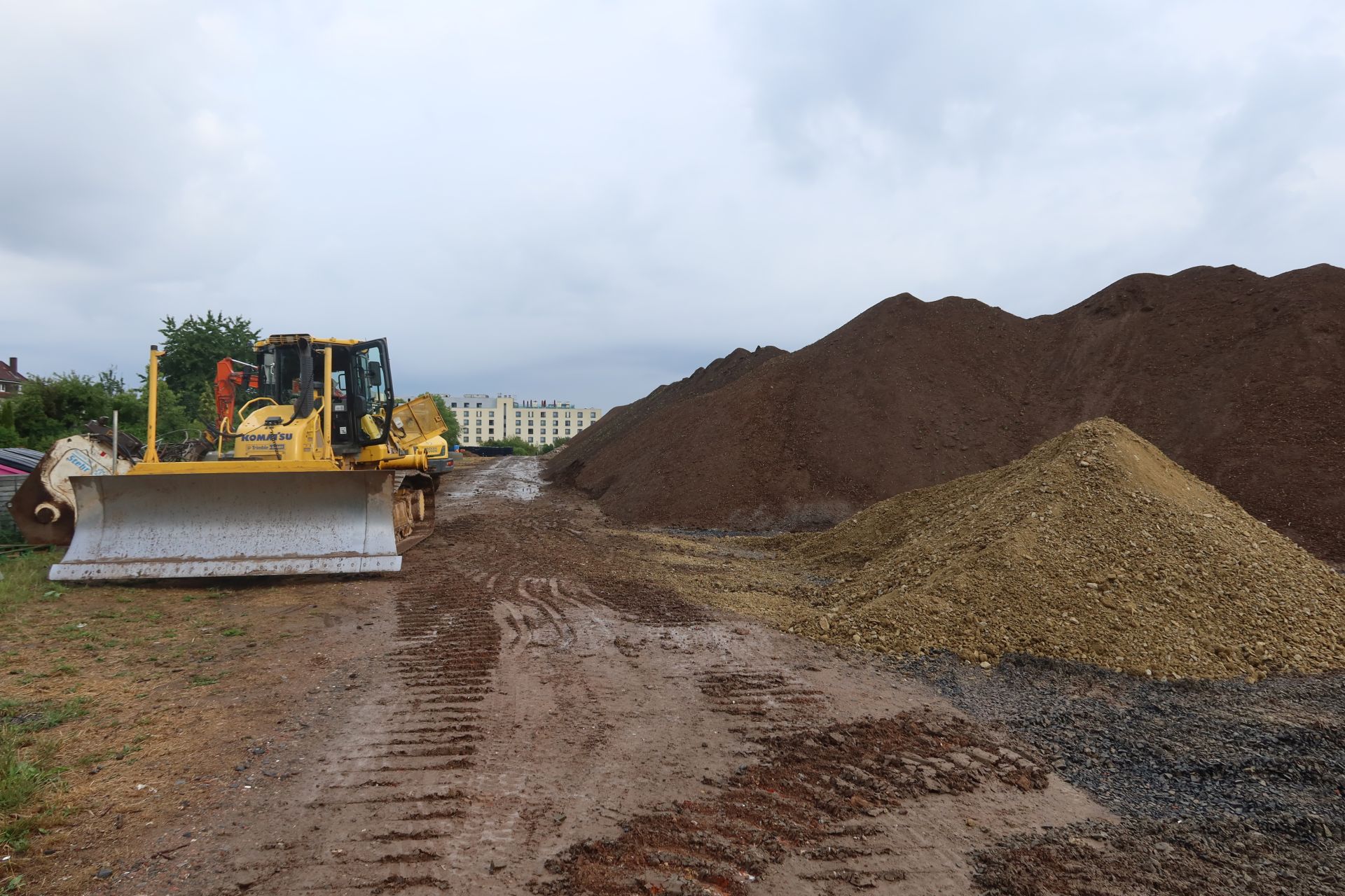 Bagger und ganz viel Sand- und Erdhaufen